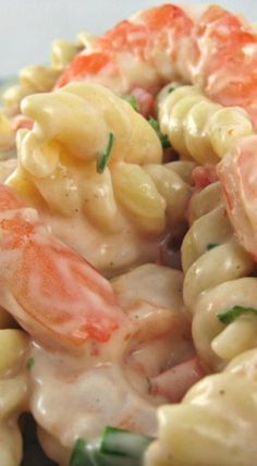 pasta salad with shrimp and asparagus on white plate, close - up view