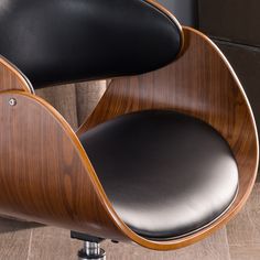 an office chair with black leather upholstered on the back and armrests