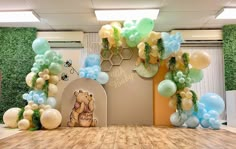 a room decorated with balloons and winnie the pooh decorations