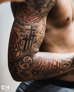 a man with tattoos on his arm and chest