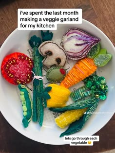 a white bowl filled with vegetables on top of a wooden table next to a sign that says, i've spent the last month making a vegetable garland for my kitchen