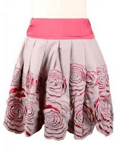 a woman's skirt with roses on the bottom and pink trimming around it