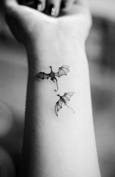 a small bat tattoo on the wrist