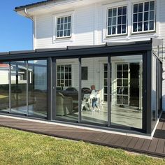 an image of a house that is being reflected in the glass doors on the outside