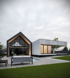 a modern house with a pool in the front yard and an outdoor seating area next to it