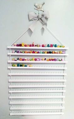 a white shelf with many items on it and a bow tie hanging from the top