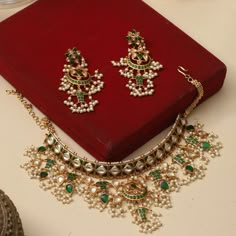 Gift yourself a royal look with this perfectly crafted kundan necklace set from Tarinika. Crafted with high quality kundan stones and pearls, it is impressive in design. The green enamel artwork adds perfect texture to the design. Perfect for weddings and festivities, this antique necklace set should be put on with your favorite sari or lehenga. Specifications: Necklace Weight:74gm, Earring Weight:24gm, Necklace Length:18cm, Earrings Length:8.5cm 100% Satisfaction Guarantee: 1 Year Warranty, Lon Classy Jewelry Silver, Antique Necklace Set, Vintage Indian Jewelry, Earring Indian, South Indian Temple, Indian Jewelry Set, Kundan Choker Set, Indian Choker Necklace, Rajputi Jewellery