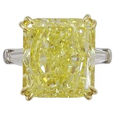 a fancy yellow diamond ring with baguets