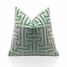 a green and white pillow sitting on top of a table