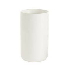 a white vase sitting on top of a table