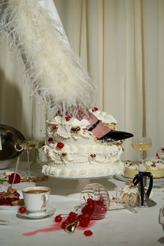 a table topped with a cake covered in white frosting