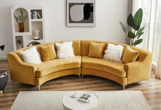 a living room filled with furniture and a white rug on top of a hard wood floor