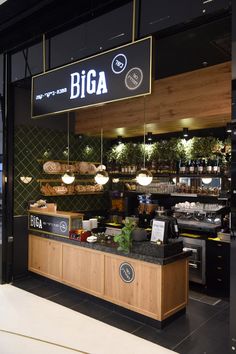 the inside of a coffee shop with lots of counter space and lights hanging from the ceiling