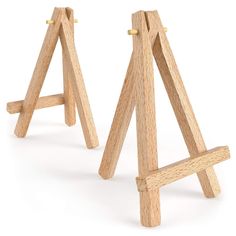 two wooden easels are standing next to each other on a white background with no one in the photo