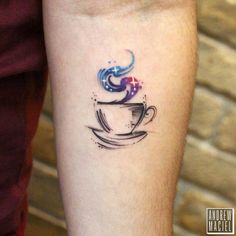 a coffee cup tattoo on the left inner arm