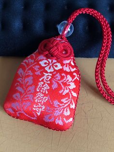 a red heart shaped bag sitting on top of a table