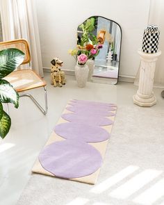 a room with a chair, mirror and rug on the floor in front of it