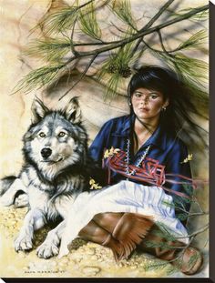 a woman sitting next to a wolf on top of a sandy ground with pine needles