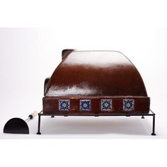 a brown leather toaster sitting on top of a metal rack with blue and yellow tiles