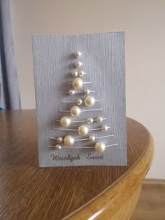 a christmas tree made out of pearls on a card