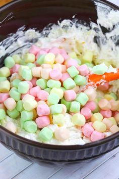 a bowl filled with marshmallows on top of a table