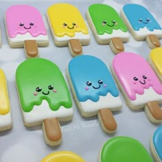 there are many ice creams with different colors on the stick and one has a smiley face