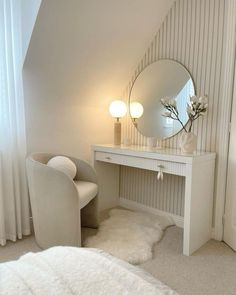 a bedroom with a chair, mirror and desk in it