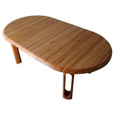 an oval wooden table with two legs and a curved design on the top, against a white background