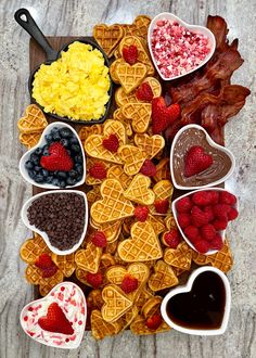 heart shaped waffles, strawberries, raspberries, chocolate hearts and other treats