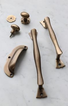 brass handles and knobs on a marble surface