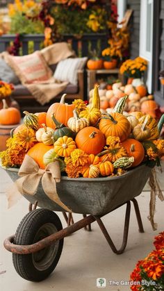 a wheelbarrow filled with pumpkins and gourds