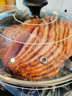 sliced meat in a glass dish on top of an electric stovetop burner oven