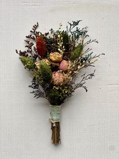 a bunch of flowers that are sitting on a white table cloth with the stems still attached to it