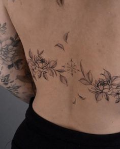 a woman's back with flowers on it