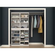 an open closet with clothes and shoes hanging on the shelves, along with other items