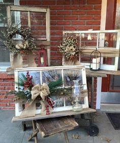 an old window is decorated with christmas wreaths and other decorations for the front porch