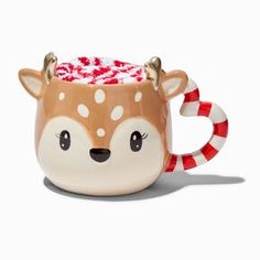 a ceramic mug with candy canes in the shape of a deer's head