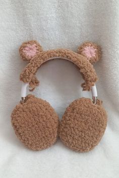 a brown teddy bear ear muffs with ears