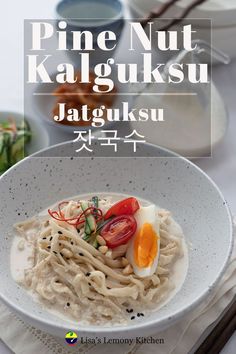 a bowl filled with noodles and vegetables on top of a table