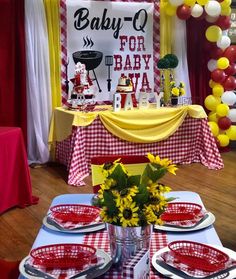 a table set for baby shower with sunflowers and red plates on the table