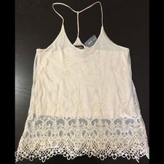 Ivory Double-Layered Camisole. Bottom Layer Is Cotton For Coverage While Top Layer Is Sheer With 3d Design Lace Embroidery. 2 Straps On Shoulders Combine Behind Neck Into 1 Strap For A Racer Back Style. This Versatile Top Can Easily Be Dressed Up Or Down For A Night Out For A Delicate Look Or A Casual Day And Still Look Cute! Brand New With Tag! (Tag Price Torn) Non-Smoking/Pet-Free Home. Spring Lace Cami Top, Sheer Lace Camisole Top, Spring Sheer Lace Camisole, Chic Lace Tank Top For Spring, Summer Beige Lace Top Tank Top, Sheer Lace Tank Top For Summer, Beige Lace Tank Top For Summer, Feminine Sheer Top With Spaghetti Straps, Beige Lace Top Tank For Summer