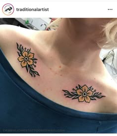 a woman's chest with two yellow flowers on the left side of her neck