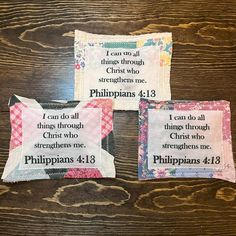 three pillows with bibles on them sitting on top of a wooden table next to each other