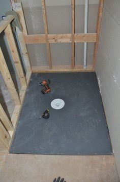 an unfinished room with some tools on the floor