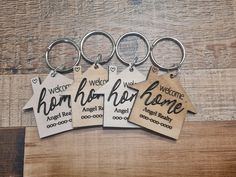 four keychains with the words welcome home on them