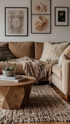 a living room filled with furniture and pictures hanging on the wall above it's coffee table