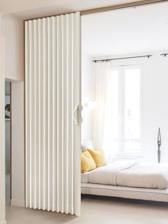 an open sliding door in a white bedroom