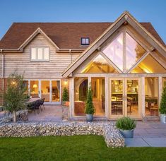 a large wooden house with glass doors and windows