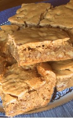 several pieces of peanut butter bars stacked on top of each other in a blue and white plate