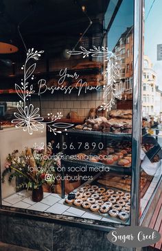 a bakery window with pastries in the front and on display behind glass that says your business name